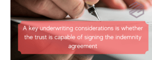 Trusts and Surety Bonds. This is a picture of a person signing a document with a red text box saying indemnity is key to writing trusts on it.